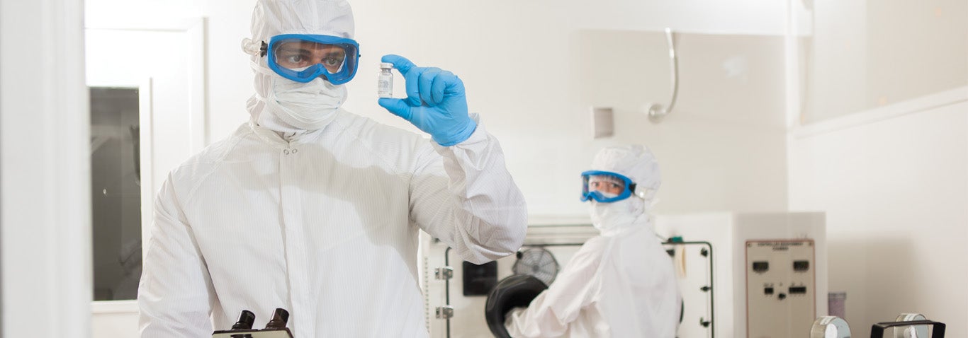 Employees working in a controlled environment wearing ESD clothing from Vestis, a leading cleanroom supplier